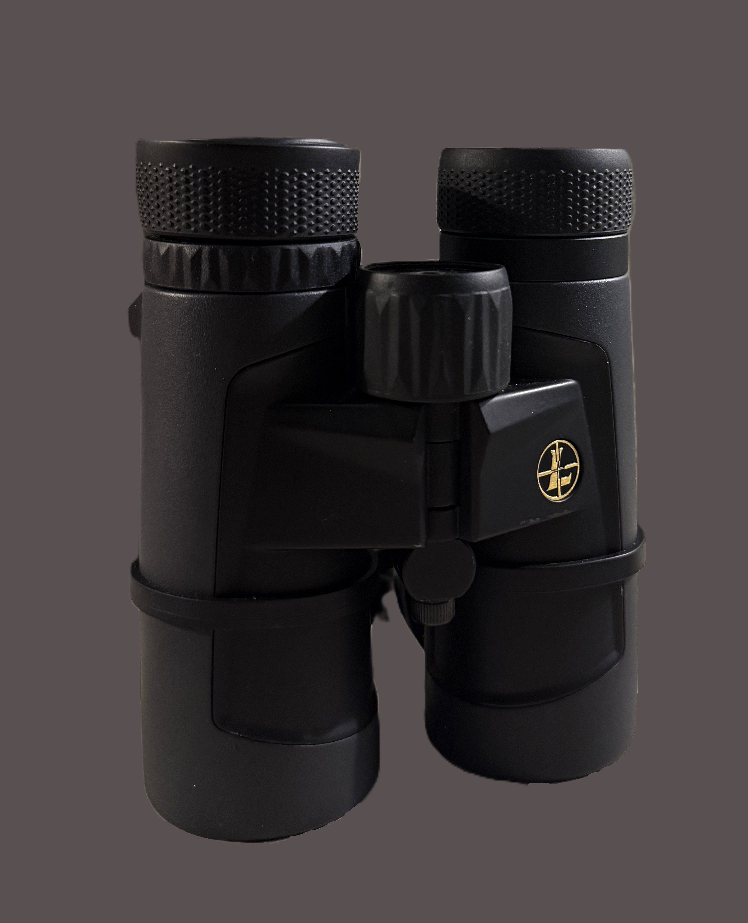 Rifle with Leupold scope resting on a pack – representative image